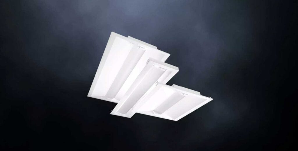Three geometric, white, recessed ceiling lights against a dark, gradient background.