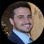 Smiling man in a suit at an event.