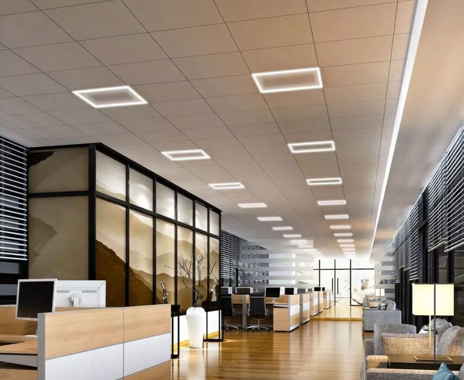 Modern office space with wooden floors, glass-walled meeting rooms, desks with computers, ceiling lights, and a lounge area with sofas.