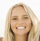 A young woman with long blonde hair smiling at the camera.